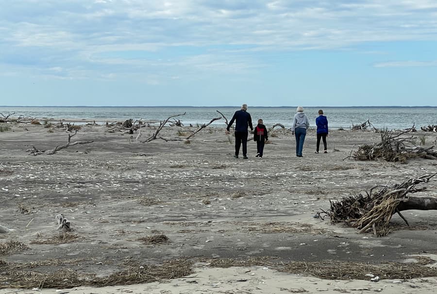 An image of a family walking on the beach at Cape Charles