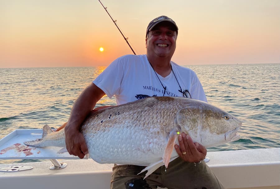 An image of an angler with a large bull red drum on the Chesapeake Bay
