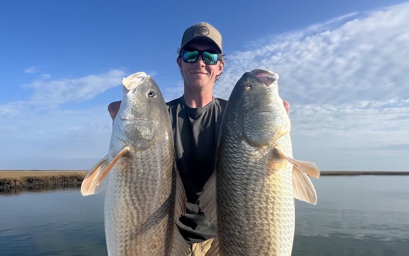 An image of an angler with a monster redfish aboard a Tidewater Cape Charles fishing charter adventure.